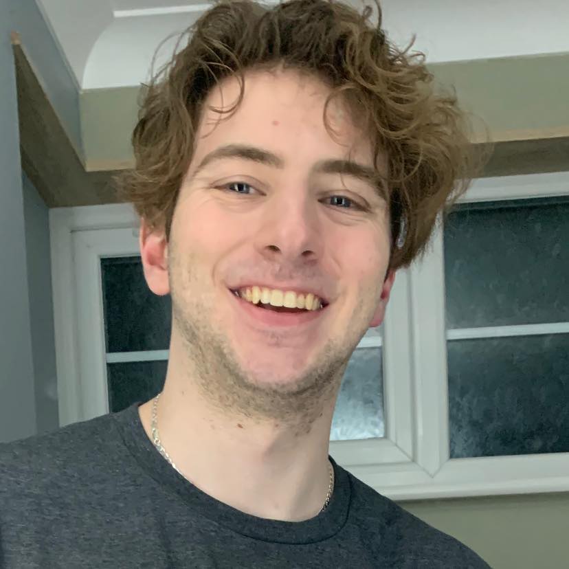 Headshot of Producer, Harry Norton with a smile on his face.